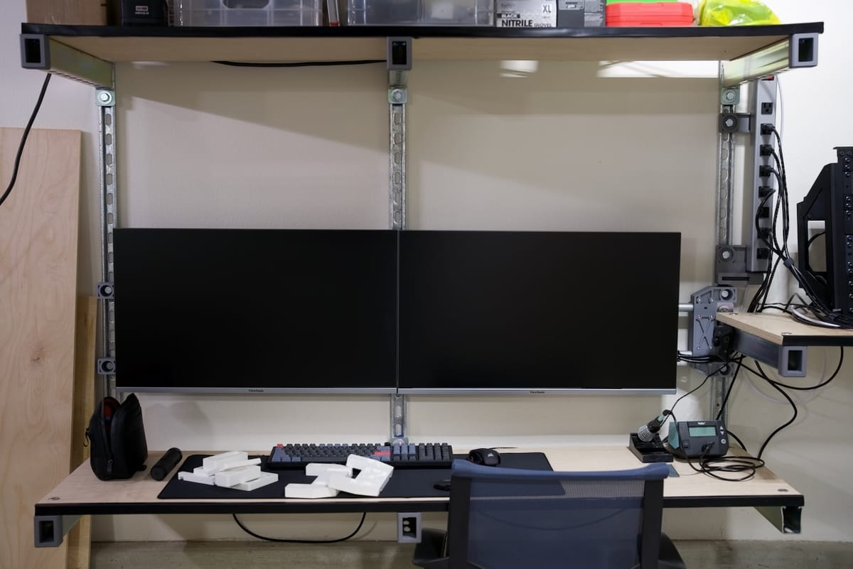 new workbench setup - steel channel, emt conduit, plywood, and of course 3d printed parts